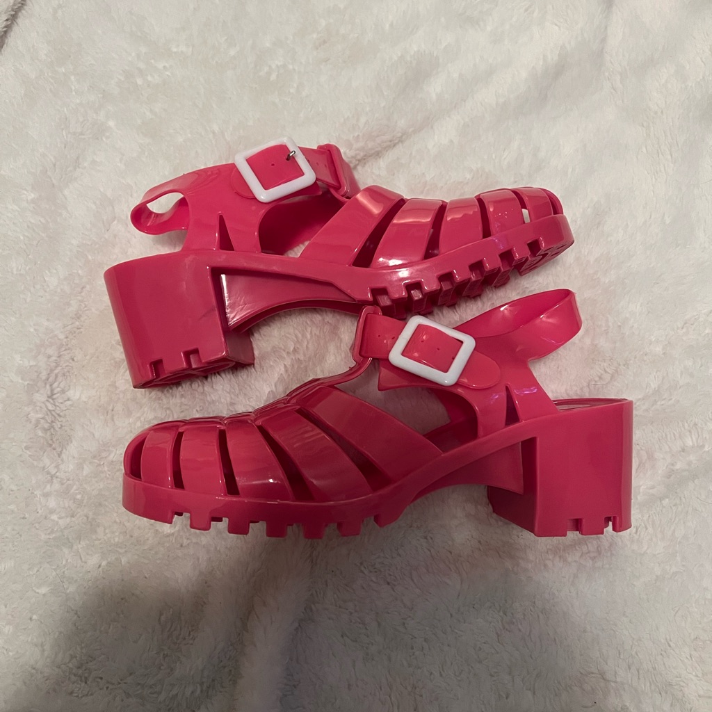 Pink moulded platform jelly sandals with buckled straps and a chunky sole